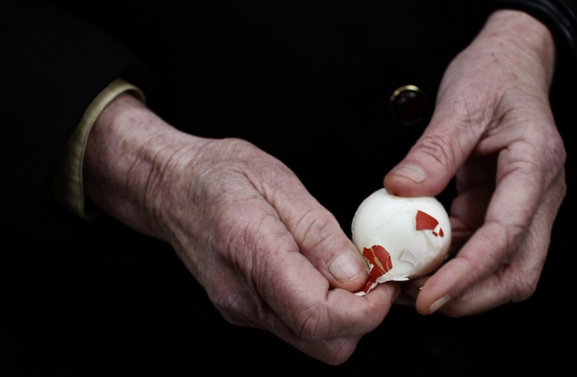 91195-a-kosovo-serb-peels-an-easter-egg-during-an-orthodox-easter-service-in
